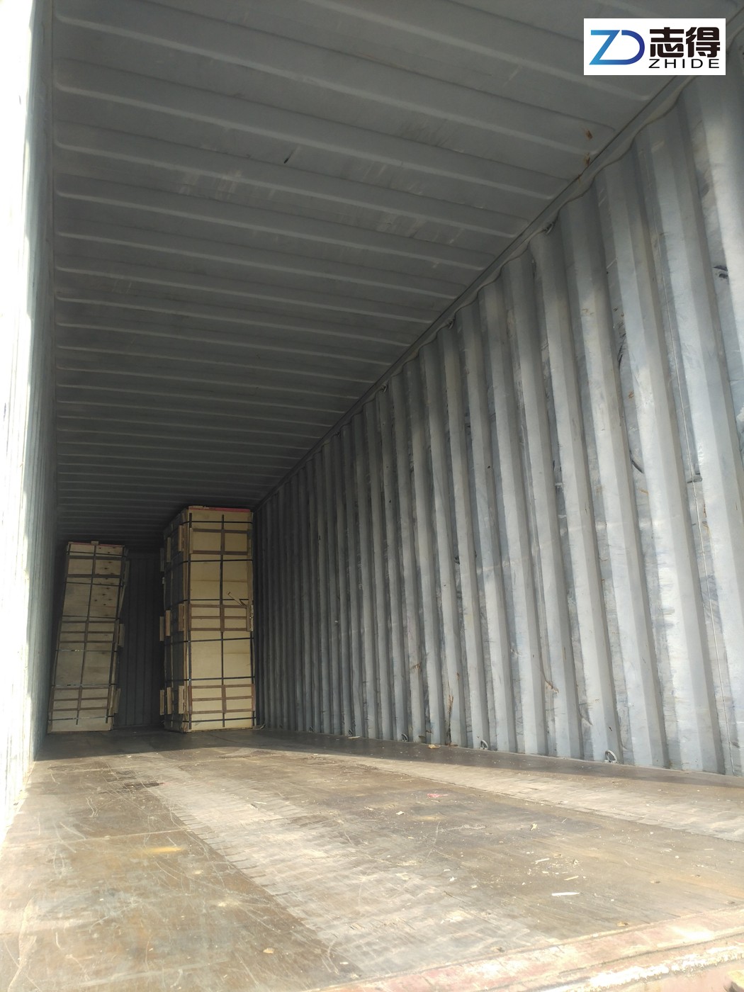 Historical photograph of packing units inside a partly loaded container