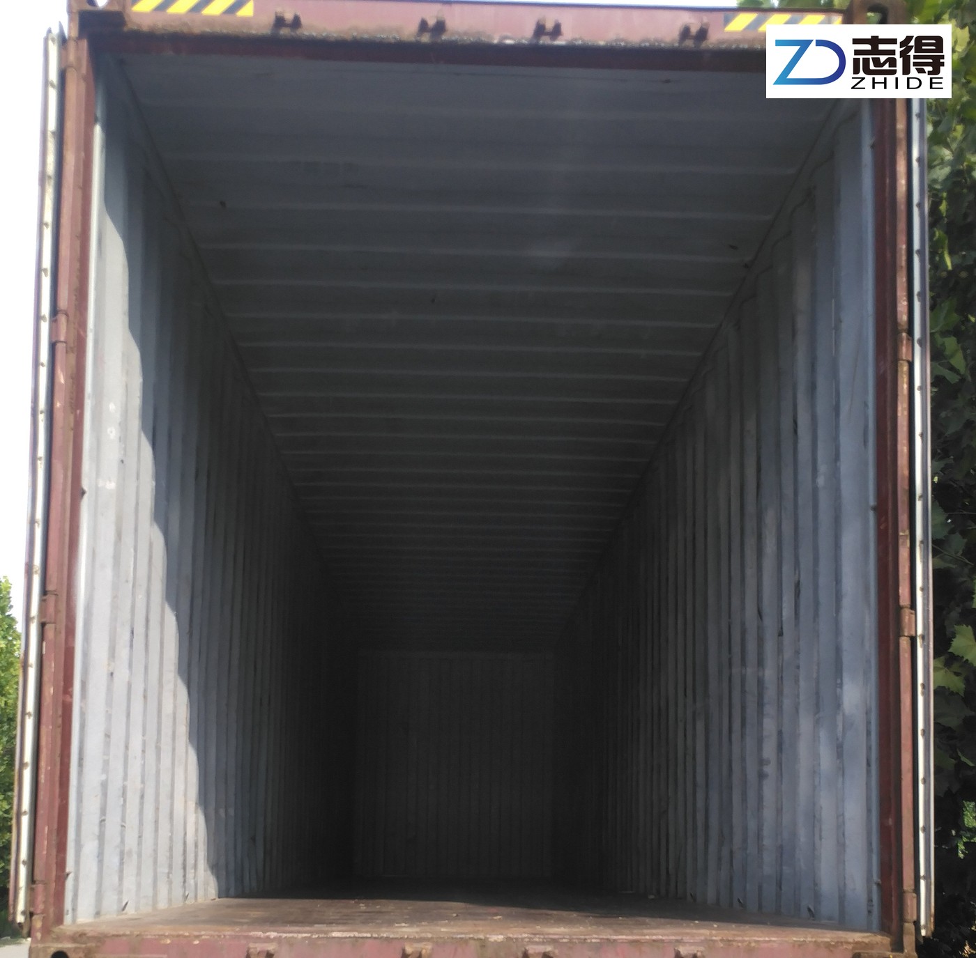 Historical photograph showing an empty shipping container before loading