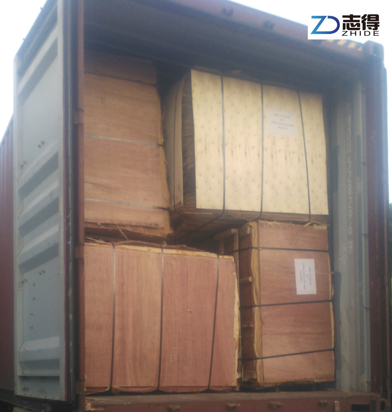 Historical photograph showing packed cargo at an open container doorway