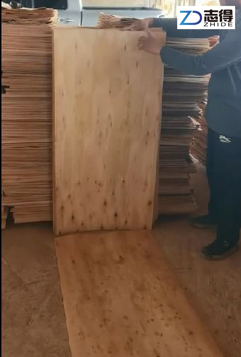 Historical eucalyptus veneer sheet photographed beside stacked sheets